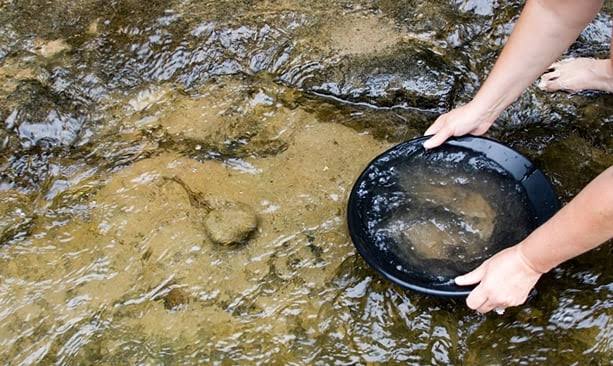 Placer gold nuggets in river gravel